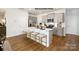 Modern kitchen with a large island, seating, stainless steel appliances, gray cabinets, and hardwood floors at 1023 Hostler Ln, York, SC 29745