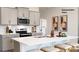 Stylish kitchen island with seating, stainless steel appliances, gray cabinets, and modern fixtures at 1023 Hostler Ln, York, SC 29745