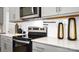 Close-up of a modern kitchen with stainless steel oven, light gray cabinets, and white subway tile backsplash at 1023 Hostler Ln, York, SC 29745