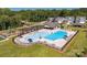 Aerial view of the community pool and amenity center with ample seating and a playground at 1023 Hostler Ln, York, SC 29745