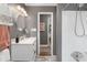 Stylish bathroom with modern vanity, a walk-in shower, tiled floors, and an artful, neutral color palette at 1100 Mona Dr, Charlotte, NC 28206
