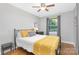 Bedroom featuring natural light from the window, hardwood floors and a cozy bed with bright yellow accents at 1100 Mona Dr, Charlotte, NC 28206