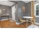 Bright dining area with hardwood floors, a round table and chairs, and stylish wall decor by a window at 1100 Mona Dr, Charlotte, NC 28206