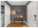 Inviting entryway featuring hardwood floors, a console table, a decorative mirror and modern lighting at 1100 Mona Dr, Charlotte, NC 28206