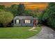 Charming bungalow with a well-manicured lawn, a stone walkway, and a vibrant red front door at 1100 Mona Dr, Charlotte, NC 28206