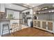 Updated kitchen featuring stainless steel appliances, a breakfast bar, open shelves, and gray accent walls at 1100 Mona Dr, Charlotte, NC 28206