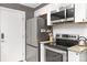Modern kitchen with stainless steel appliances, granite countertops, white subway tile, and stylish fixtures at 1100 Mona Dr, Charlotte, NC 28206
