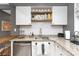 Modern kitchen with granite countertops, white cabinetry, stainless steel appliances, and decorative shelving at 1100 Mona Dr, Charlotte, NC 28206