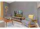 Cozy living room featuring a flat screen TV, modern furniture and stylish decor against neutral gray walls at 1100 Mona Dr, Charlotte, NC 28206