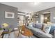Comfortable living room with modern decor, plush sofa, and views into the updated kitchen at 1100 Mona Dr, Charlotte, NC 28206
