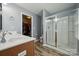 Bathroom boasts a double sink vanity, wood flooring, and a glass-enclosed shower next to a walk-in closet at 1180 Bannockburn Ave, Rock Hill, SC 29732