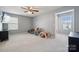 Spacious bedroom with natural light, featuring a ceiling fan and ample space for play and relaxation at 1180 Bannockburn Ave, Rock Hill, SC 29732