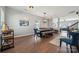 Spacious dining room with wooden table, blue chairs, and a modern chandelier at 1180 Bannockburn Ave, Rock Hill, SC 29732