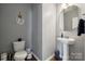 Well-maintained half-bathroom with sleek fixtures, a modern vanity, and a decorative mirror at 1180 Bannockburn Ave, Rock Hill, SC 29732