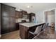 Stylish kitchen features dark cabinetry, granite countertops, stainless steel appliances, and a convenient island with seating at 1180 Bannockburn Ave, Rock Hill, SC 29732