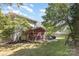 Large backyard with a covered patio, fire pit, seating, mature trees, a swing, and privacy fencing at 11807 Hawick Valley Ln, Charlotte, NC 28277