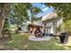 Expansive backyard featuring a covered patio with outdoor seating, a swing, and mature trees at 11807 Hawick Valley Ln, Charlotte, NC 28277
