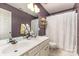 Inviting bathroom featuring a double sink vanity with white cabinets and tiled flooring at 11807 Hawick Valley Ln, Charlotte, NC 28277