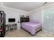 Cozy bedroom featuring neutral walls, carpet flooring, a bed, and a window offering natural light at 11807 Hawick Valley Ln, Charlotte, NC 28277