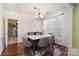 Bright dining room featuring a modern table with seating for six and a chandelier at 11807 Hawick Valley Ln, Charlotte, NC 28277