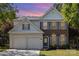 Charming two-story home with brick and siding, complemented by a manicured lawn and a two-car garage at 11807 Hawick Valley Ln, Charlotte, NC 28277