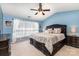 Main bedroom with a tray ceiling, large bed and dark furniture at 11807 Hawick Valley Ln, Charlotte, NC 28277