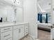 Modern bathroom featuring a white vanity with double sinks and a view into the bedroom at 119 Berkeley Ave # A, Mooresville, NC 28117