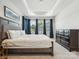 Bright and airy bedroom with large windows, tray ceilings and a gray toned palette at 119 Berkeley Ave # A, Mooresville, NC 28117