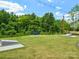 Grassy community area with bench seating and cornhole game sets, perfect for outdoor gatherings at 119 Berkeley Ave # A, Mooresville, NC 28117