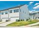 View of the home's exterior highlighting the garage, lawn and neighborhood at 119 Berkeley Ave # A, Mooresville, NC 28117