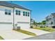 View of the home's exterior highlighting the garage, lawn and neighborhood at 119 Berkeley Ave # A, Mooresville, NC 28117