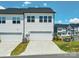 View of the home's exterior highlighting the garage, lawn and neighborhood at 119 Berkeley Ave # A, Mooresville, NC 28117
