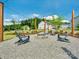 Community fire pit area with Adirondack chairs on a gravel base, surrounded by manicured landscaping at 119 Berkeley Ave # A, Mooresville, NC 28117