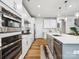 Modern kitchen featuring white cabinets, stainless steel appliances, and a spacious island at 119 Berkeley Ave # A, Mooresville, NC 28117