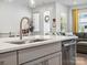 View of the kitchen sink with stainless steel appliances and a view to the open floorplan beyond at 119 Berkeley Ave # A, Mooresville, NC 28117