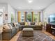 Bright living room featuring large windows, a comfortable sofa, and stylish decor at 119 Berkeley Ave # A, Mooresville, NC 28117
