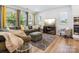 Bright living room with large windows, comfortable seating, and modern decor at 119 Berkeley Ave # A, Mooresville, NC 28117