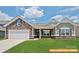 Charming home featuring a stone facade, well-manicured lawn, and a welcoming covered porch at 6320 Busch Way, Midland, NC 28107