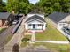 Aerial view of a charming bungalow with new roof, green yard, and cozy curb appeal at 1211 N Boyce St, Gastonia, NC 28052