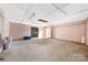 Unfinished basement featuring concrete floors, block walls, and ample space for future development at 1211 N Boyce St, Gastonia, NC 28052