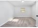 Bedroom featuring neutral carpet, crisp white walls, and natural light streaming through the window at 1211 N Boyce St, Gastonia, NC 28052