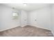This bedroom features neutral carpet, paint, one window, and two closets for storage at 1211 N Boyce St, Gastonia, NC 28052
