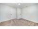 This bedroom features neutral carpet, paint, one window, and two closets for storage at 1211 N Boyce St, Gastonia, NC 28052
