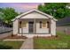 Charming white brick home with inviting front porch and rustic wood columns at 1211 N Boyce St, Gastonia, NC 28052