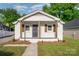 Charming renovated bungalow with white brick, black door, and stylish wood columns at 1211 N Boyce St, Gastonia, NC 28052