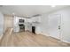Modern kitchen with sleek white cabinetry, stainless steel appliances, and light wood flooring at 1211 N Boyce St, Gastonia, NC 28052