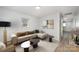 Inviting living room features a neutral sectional sofa, minimalist decor, and modern light fixtures at 1211 N Boyce St, Gastonia, NC 28052