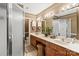 Bathroom with wooden vanity, double sinks, large mirror, and a tiled floor at 1261 Hawthorne Dr, Indian Trail, NC 28079