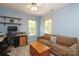 Light blue bedroom featuring a comfortable couch and computer desk with shelving at 1261 Hawthorne Dr, Indian Trail, NC 28079