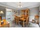 Elegant dining area with a wood table, wainscoting, and modern light fixture at 1261 Hawthorne Dr, Indian Trail, NC 28079